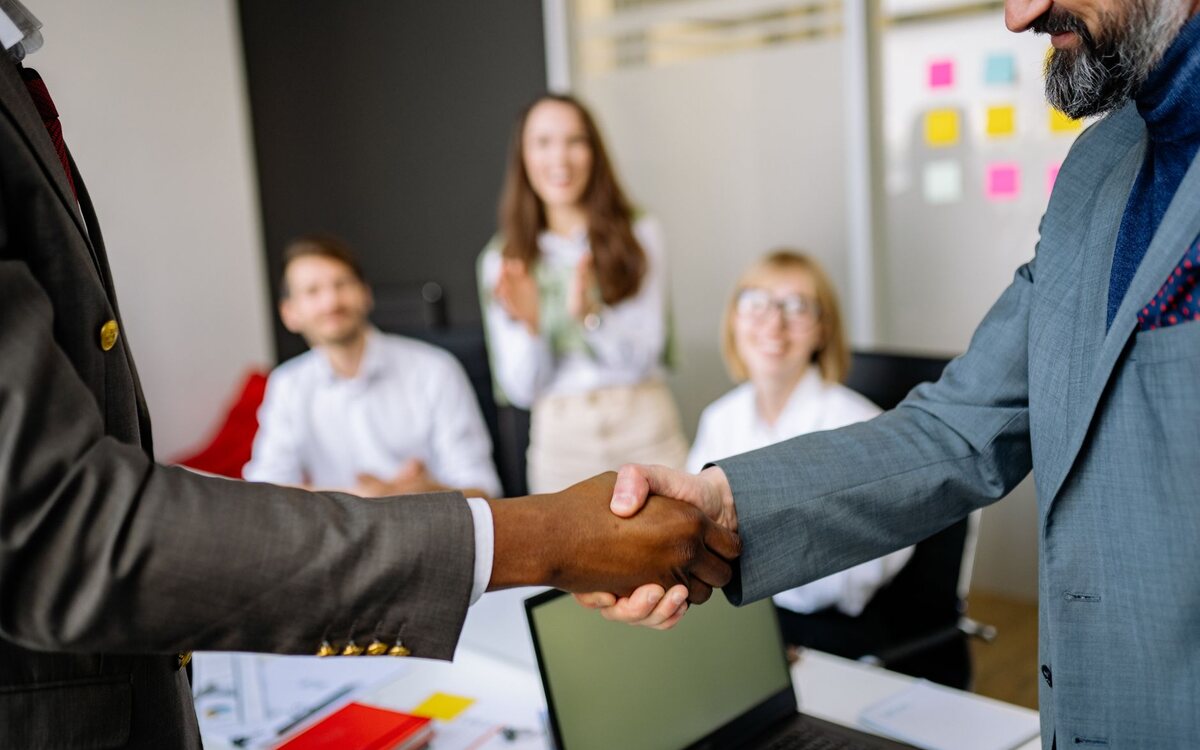 Two people shaking hands in a business meeting